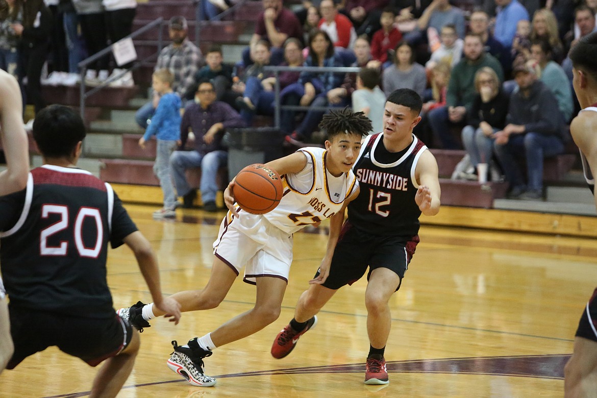 Moses Lake freshman Tyce Miller shakes past a Sunnyside defender on his way to the rim.