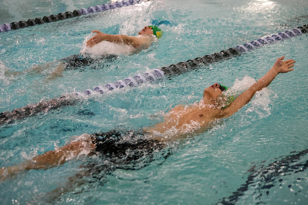 Zane Meuter and Hayden Knauer compete in the boys 100 backtroke at the wave on Friday. (JP Edge/Hungry Horse News)