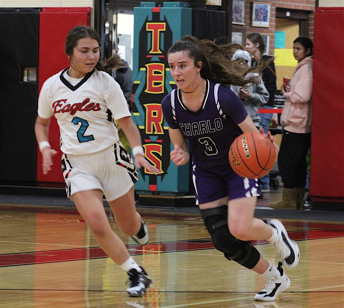 Charlo's Hayleigh Smith and Two Eagle River's Olivia Brueggeman head down the court in Thursday's game. (Ginger Zempel photo)