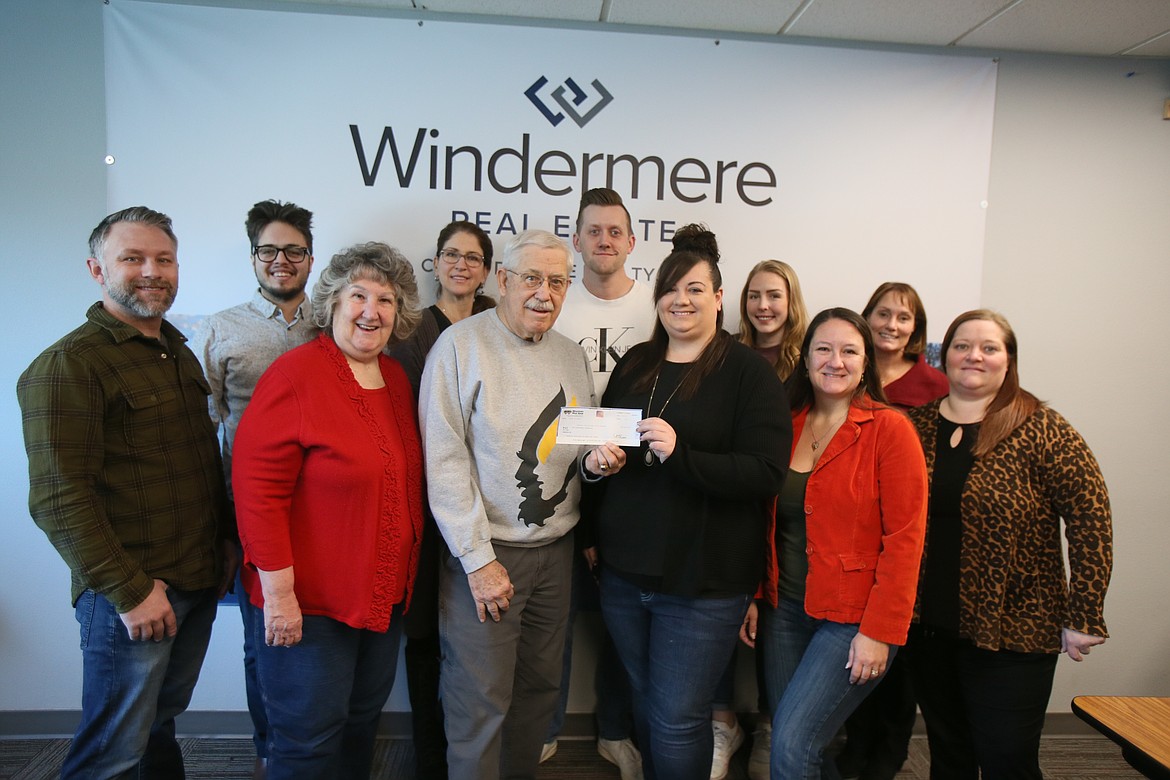 Bras on Dudes committee members on Monday present the Windermere Foundation with $30,000 raised at the November event to support local cancer patients. Front row, from left: Nate Breazile, Karen Hansen, Dick Jurvelin, Brandie Binfield, Holly Hansen and Jenna Ahearn. Back row, from left: Tyler Zoesch, Jennifer Jenkins, Isaac Loren, Lacie Griffin and Brooke Breckenridge.