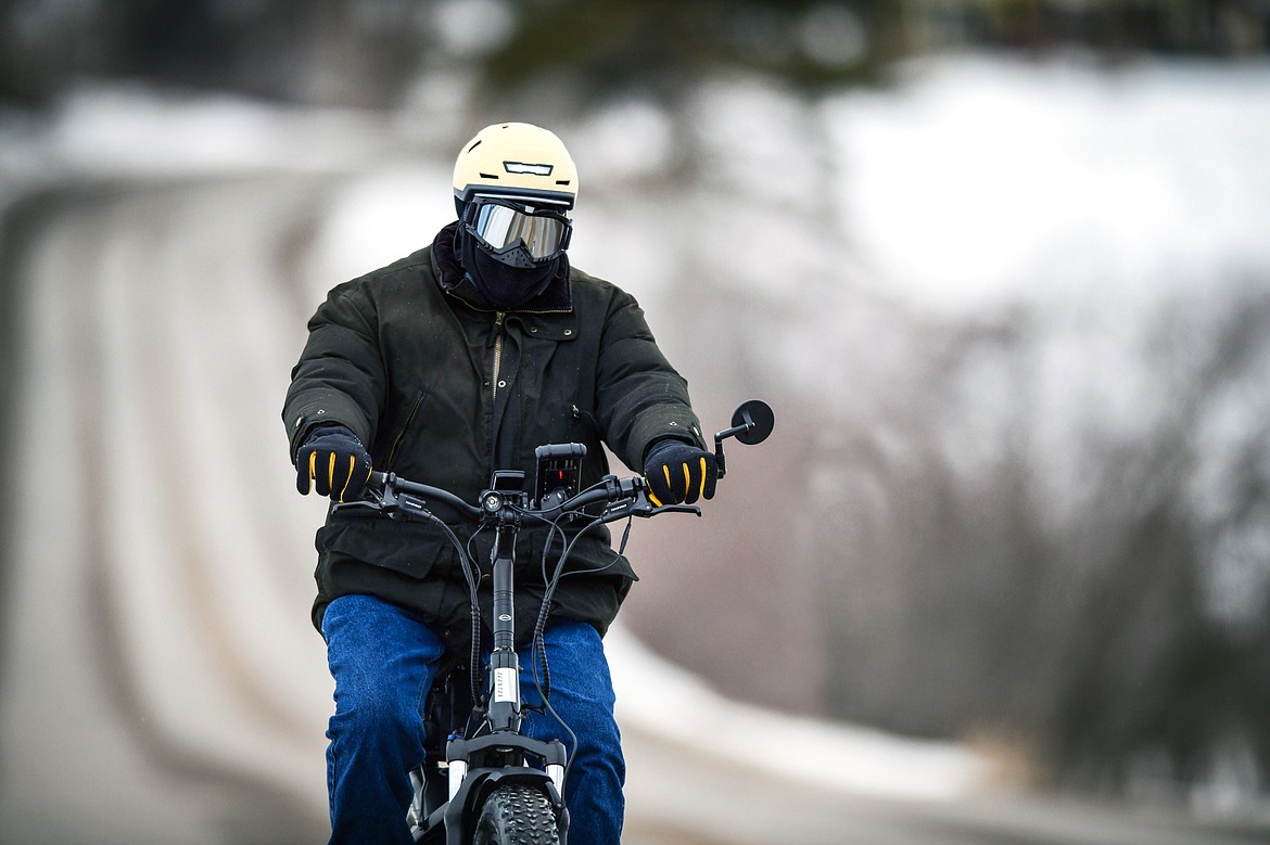 Dan McQueen bundles up for a pedal along Holt Stage on Friday, Jan. 20. (Casey Kreider/Daily Inter Lake)
