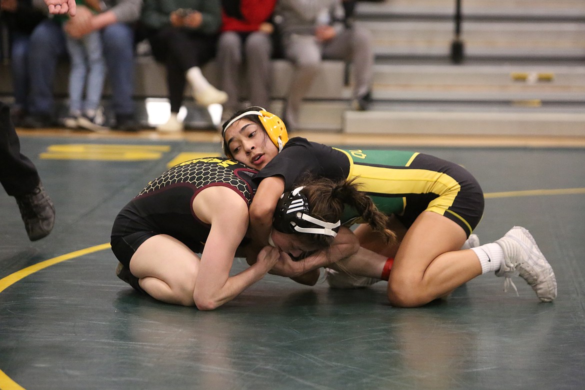 Quincy sophomore Alondra Cordova, right, wrestles against Moses Lake senior Brianna Martinez in the 115-pound third-place match at Saturday’s Bring Home Da Beef girls wrestling tournament.