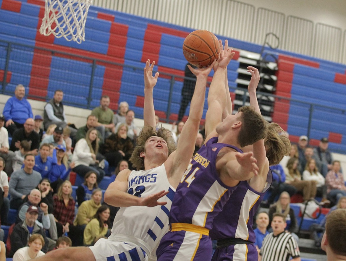 JASON ELLIOTT/Press
Coeur d'Alene senior center Alexander Nipp (12) battles for the rebound with Lewiston junior forward Drew Hottinger (24) during the fourth quarter of Tuesday's Inland Empire League game at Viking Court.