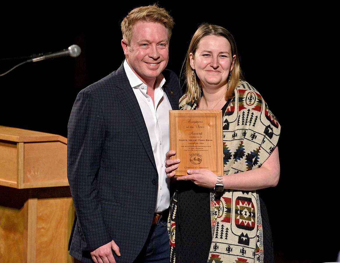 The North Valley Food Bank won Business of the Year at the Whitefish Chamber Awards Gala. Eric Schmidt of First Interstate Bank presents Sophie Albert, NVFB executive director, with the award on Thursday evening at the O'Shaughnessy Center. (Whitney England/Whitefish Pilot)