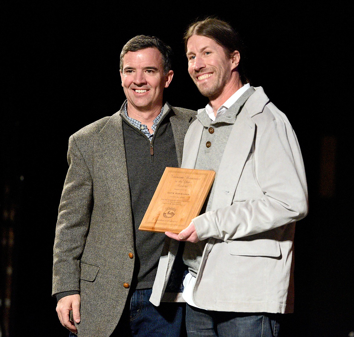 Cafe Kandahar head chef and owner Andy Blanton accepts the Tourism Business of the Year award presented by Whitefish Mountain Resort president Nick Polumbus at the Whitefish Chamber Awards Gala Thursday. (Whitney England/Whitefish Pilot)