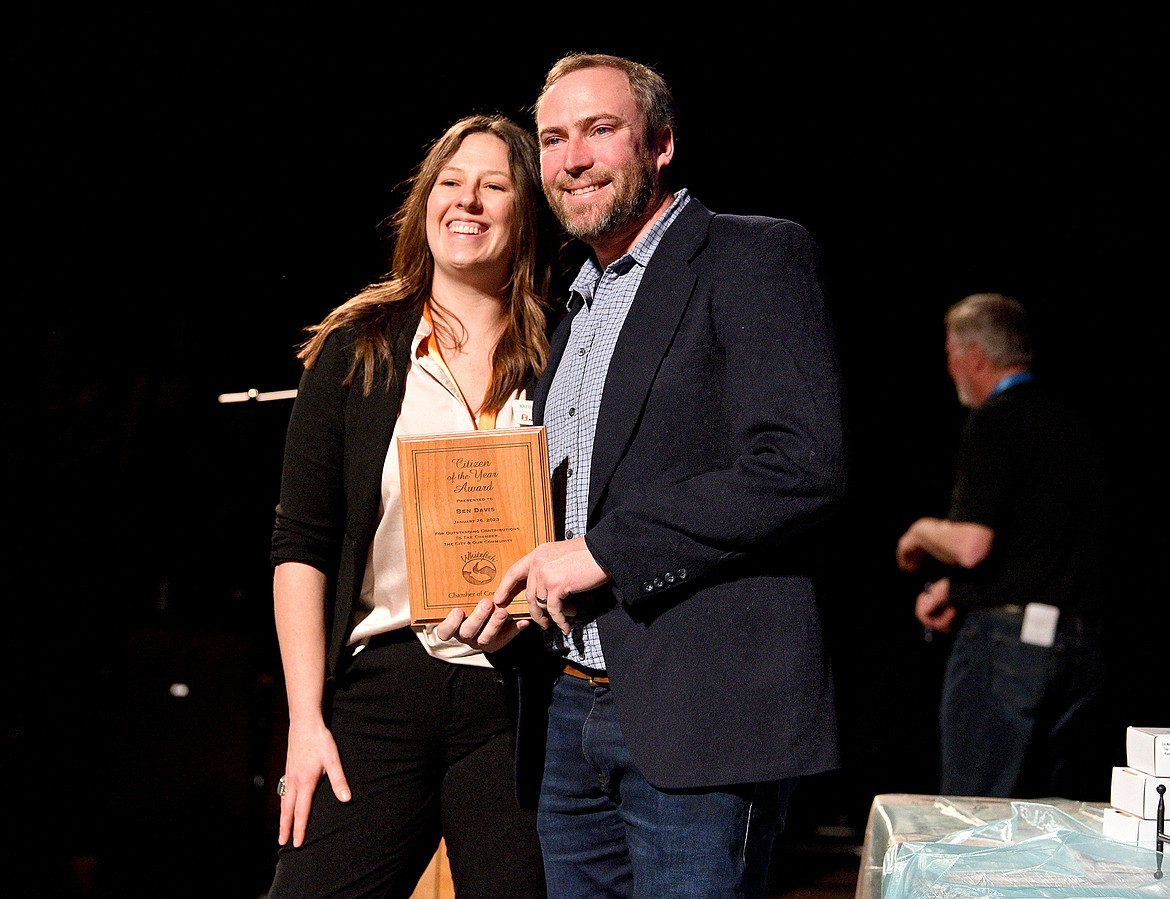 City Councilor Ben Davis accepts the Citizen of the Year award from Katie Williams at the Whitefish Chamber Awards Gala Thursday. (Whitney England/Whitefish Pilot)