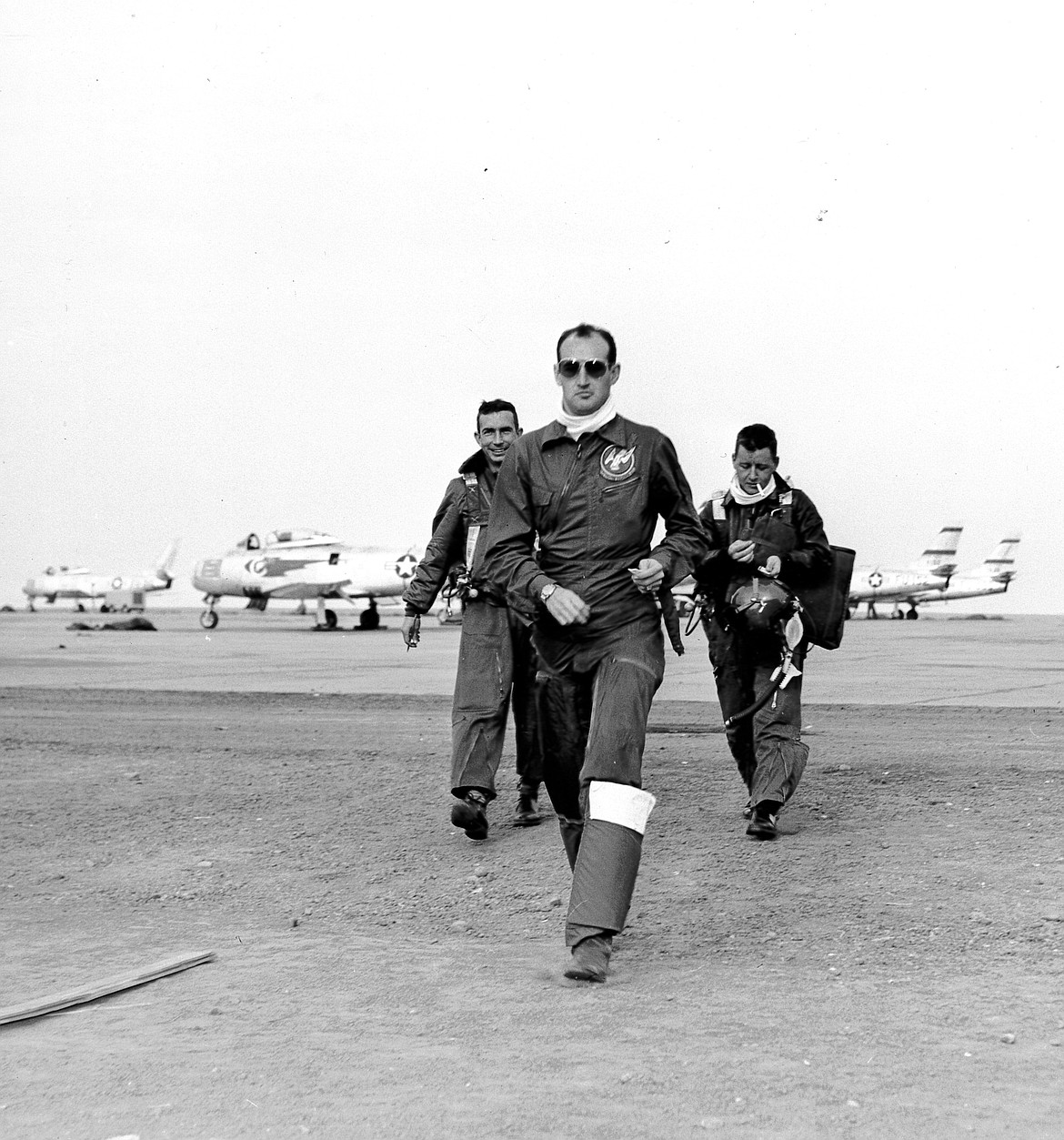 Three pilots with the 71st Fighter Squadron swagger from their fighter jets at Larson Air Force Base sometime in the summer of 1950. The photo is one of 16 found in a storage space in Southern California in 2022 that were donated to the Port of Moses Lake.