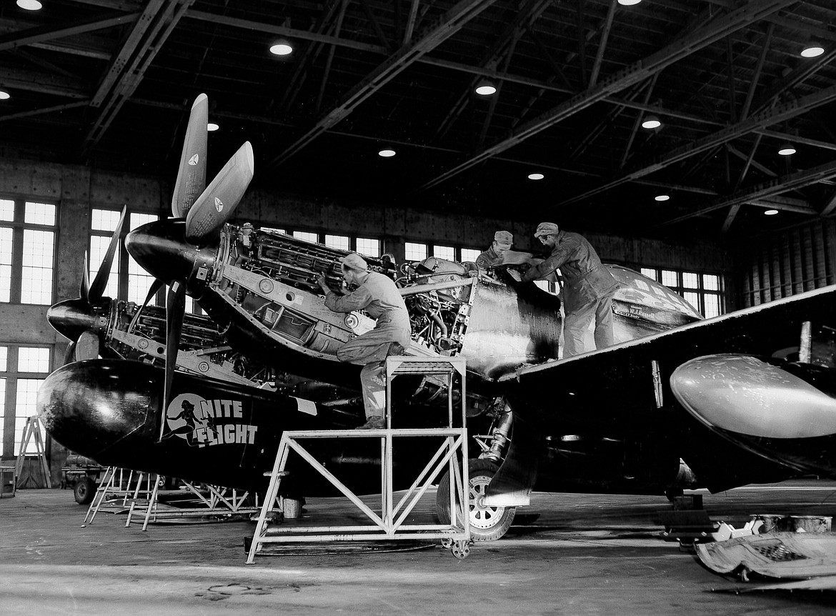 U.S. Air Force mechanics in a hangar at Larson Air Force Base work on an F-82 Twin Mustang. The USAF began replacing the Twin Mustang in late 1950 with faster and more capable jet fighters.