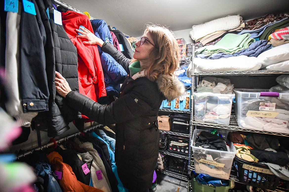 Julie Sherrick, the volunteer supply coordinator, organizes donated items inside the supply closet at the Flathead Warming Center in Kalispell on Wednesday, Feb. 1. (Casey Kreider/Daily Inter Lake)