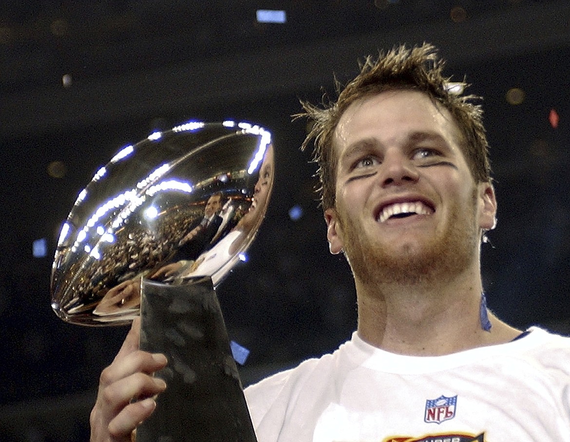 In this Feb. 1, 2004, file photo, New England Patriots quarterback Tom Brady holds the Vince Lombardi Trophy after the Patriots beat the Carolina Panthers 32-29 in Super Bowl 38 in Houston. Brady, who won a record seven Super Bowls for New England and Tampa, has announced his retirement, Wednesday, Feb. 1, 2023. (AP Photo/Dave Martin, File)