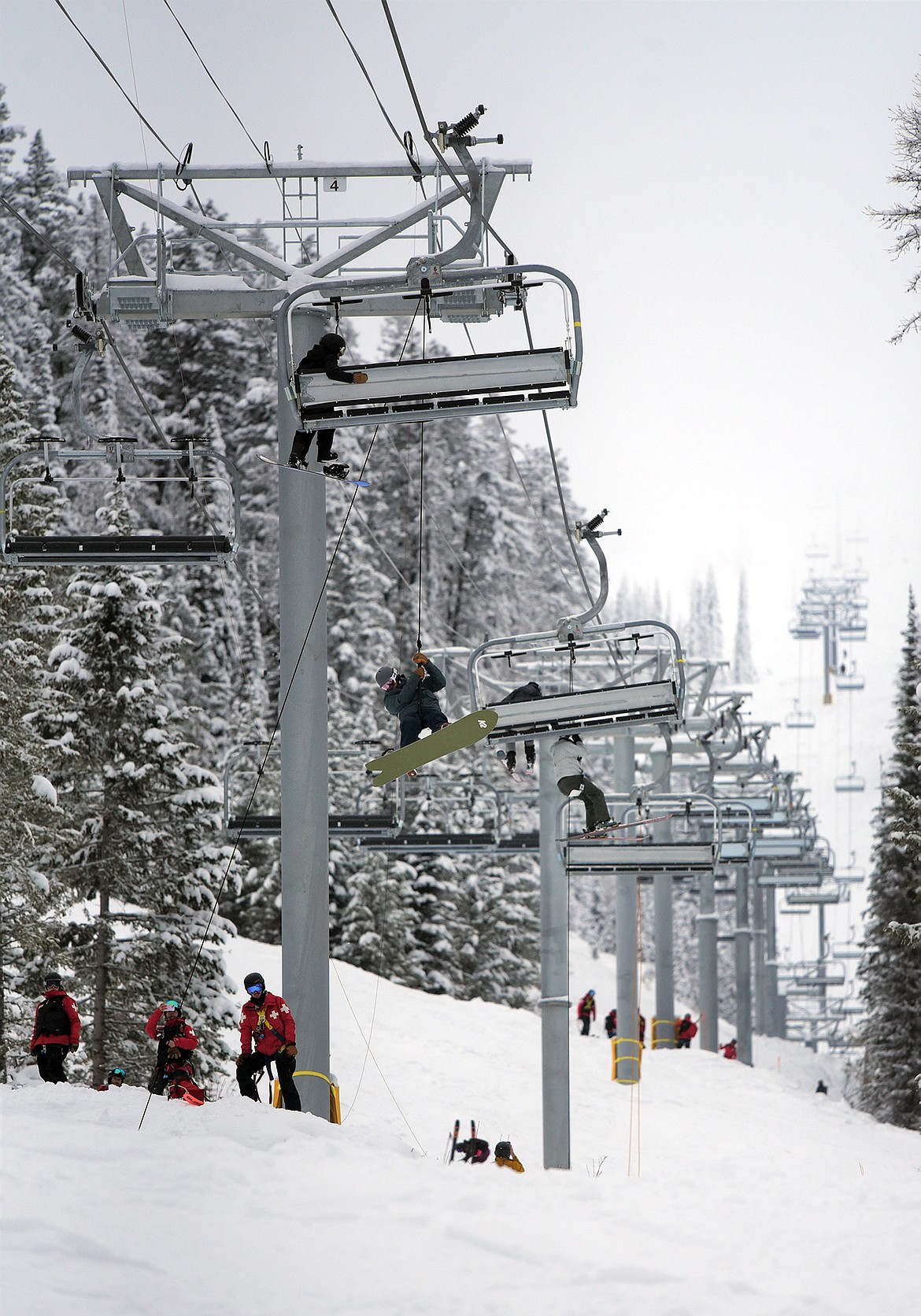 Whitefish Mountain Resort ski patrollers evacuate skiers and snowboarders from the Chair 4 lift on Wednesday, Feb. 1, 2023. (Adrian Knowler/Daily Inter Lake)