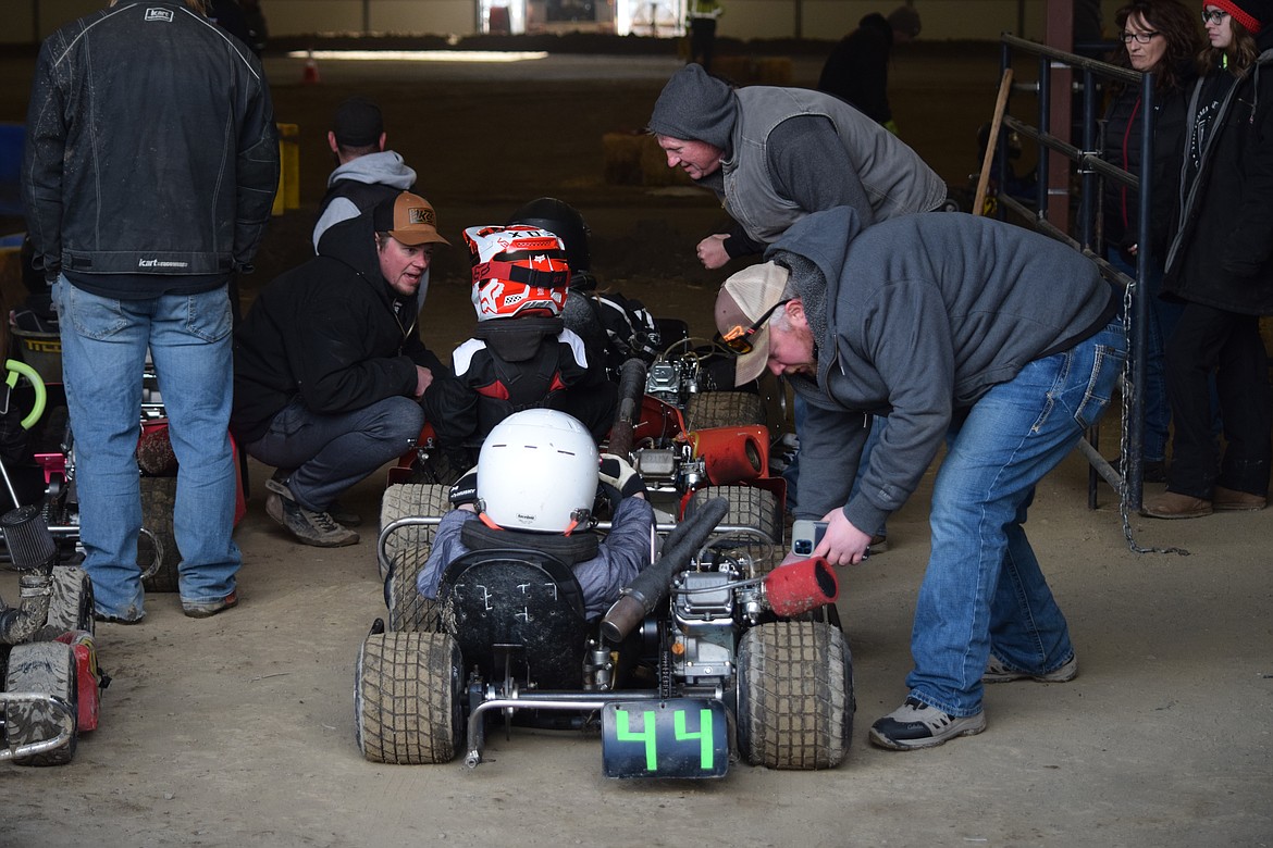 Adults give pep talks and prepare young go-kart racers for their first race at the Grant County Fairgrounds on Saturday.