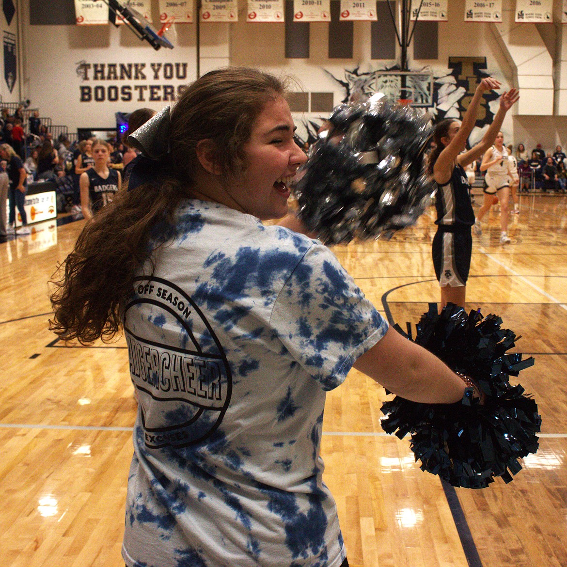 Badger cheerleader Hailey Kelsey leads the crowd in a sideline cheer.