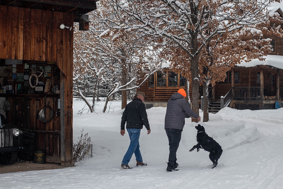 Pat Nissen and his son Jake are seen on their property with their dog Oso on Feb. 1, 2023. (Kate Heston/Daily Inter Lake)