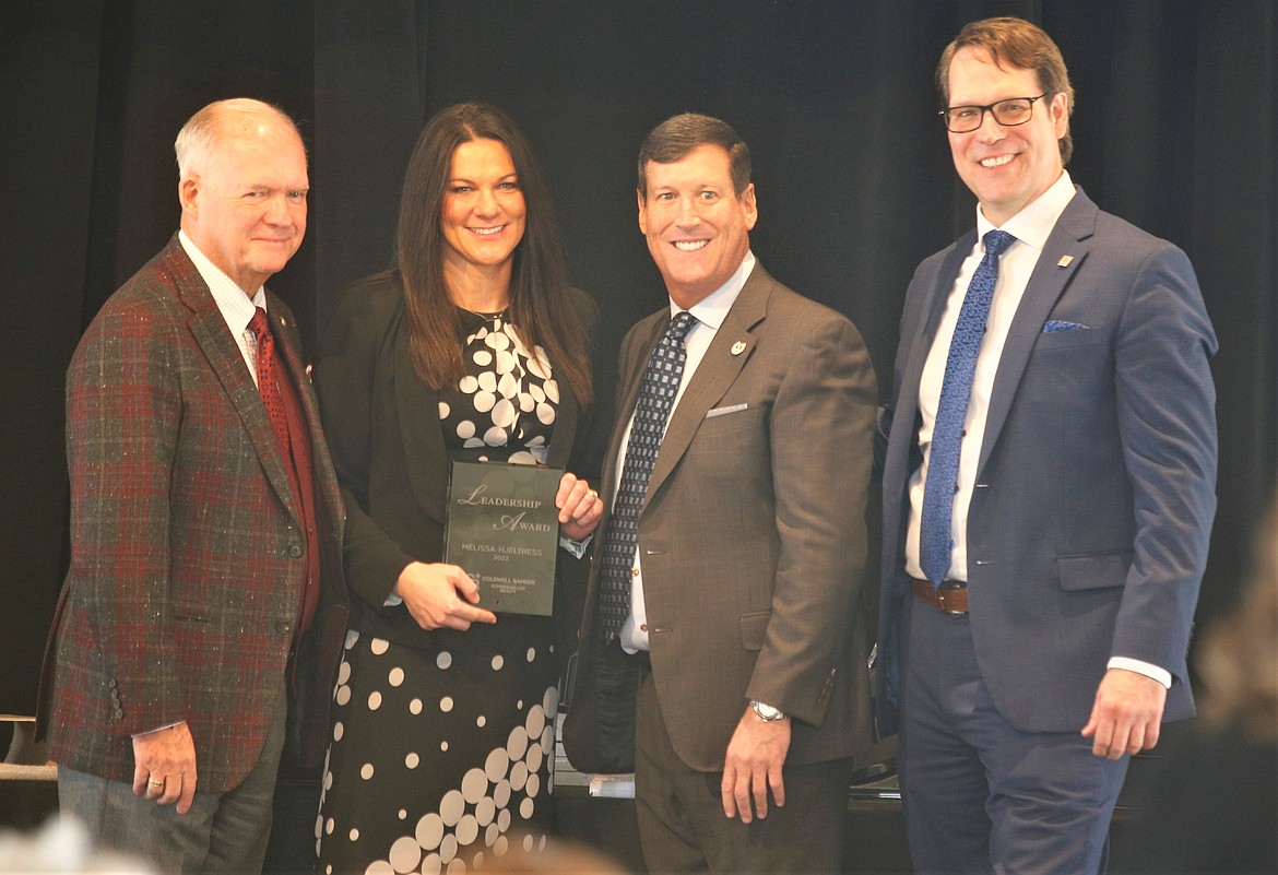 Melissa Hjeltness receives the Leadership Award at Coldwell Banker Schneidmiller Realty's annual awards banquet at the Hagadone Event Center on Thursday. She is joined by the leadership team, from left, Gary Schneidmiller, Mark Johnson and Rob Brickett.