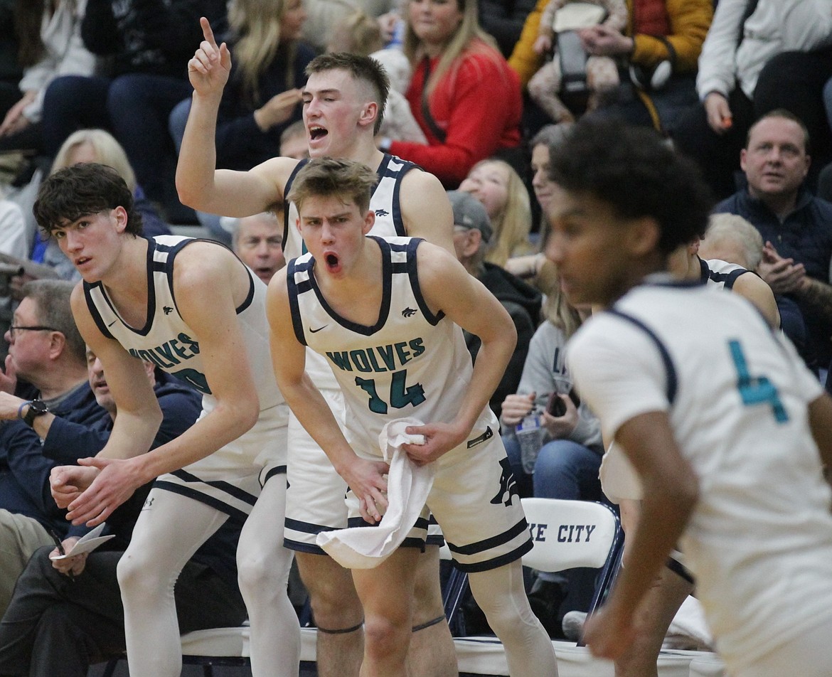 MARK NELKE/Press
Along with his Lake City teammates Blake Buchanan, left, and Zach Johnson, rear, Kolton Mitchell (14) cheers on a teammate during last Saturday's game vs. Coeur d'Alene.