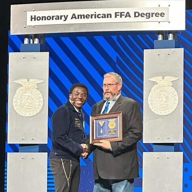 Quincy ag teacher Rod Cool receives an Honorary American FFA award, the organization’s highest award for non-members, at the 2022 National FFA convention.