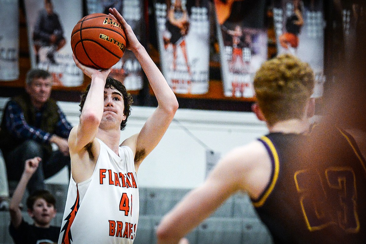 Flathead's Noah Cummings (4) shoots a three in the fourth quarter against Missoula Sentinel at Flathead High School on Friday, Feb. 3. (Casey Kreider/Daily Inter Lake)