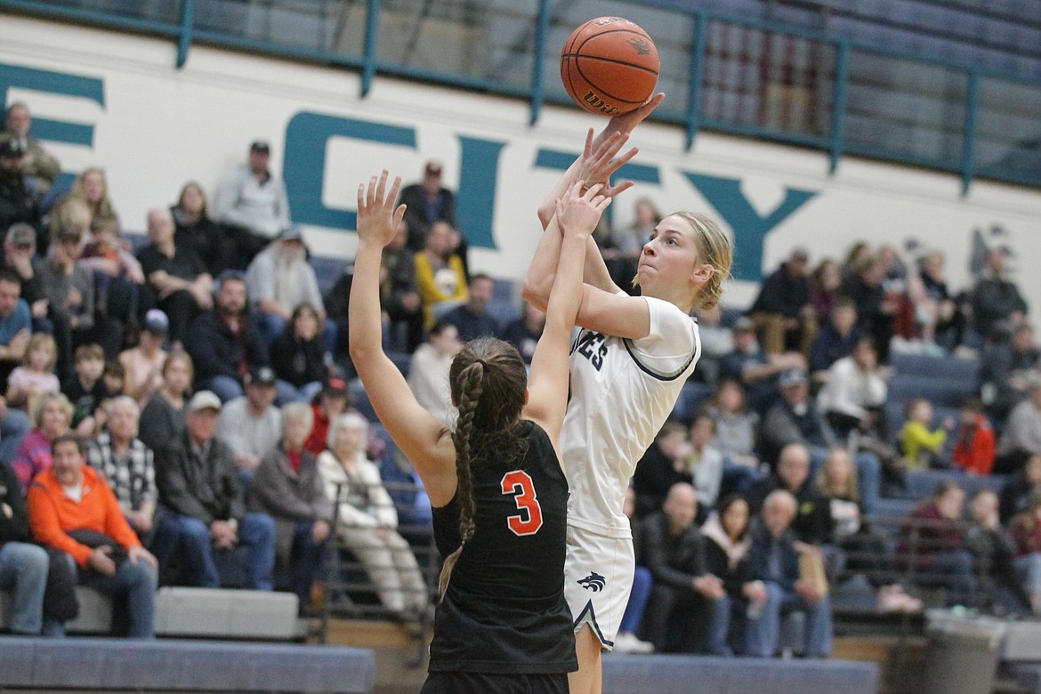 JASON ELLIOTT/Press
Lake City junior guard Avery Waddington shoots over the defense of Post Falls junior guard Katie Berg in the third quarter of Friday's 5A Region 1 girls basketball tournament game at Lake City High.