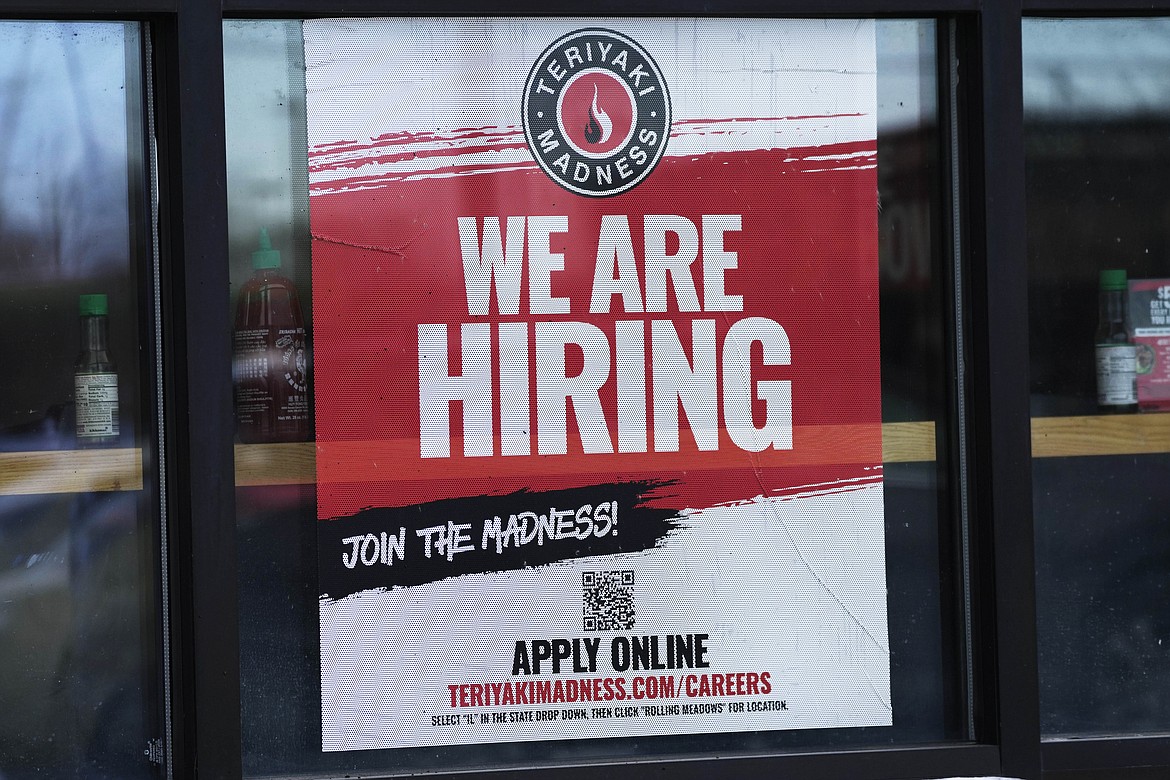 A hiring sign is displayed at a restaurant in Rolling Meadows, Ill., Monday, Jan. 30, 2023. America’s employers added a robust 517,000 jobs in January, a surprisingly strong gain in the face of the Federal Reserve’s aggressive drive to slow growth and tame inflation with higher interest rates.(AP Photo/Nam Y. Huh)