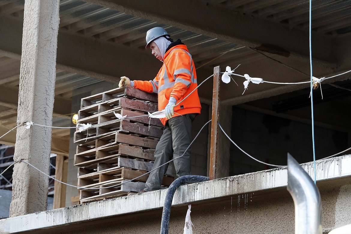 A construction worker pauses at a building site, Thursday, Jan. 26, 2023, in Boston. America's employers added a robust 517,000 jobs in January, a surprisingly strong gain in the face of the Federal Reserve's aggressive drive to slow growth and tame inflation with higher interest rates.(AP Photo/Michael Dwyer)