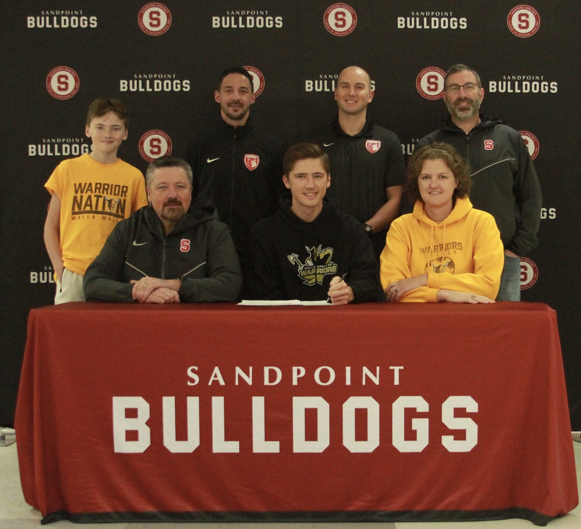 Evan Dickinson signs his national letter of intent to play soccer for Walla Walla Community College.