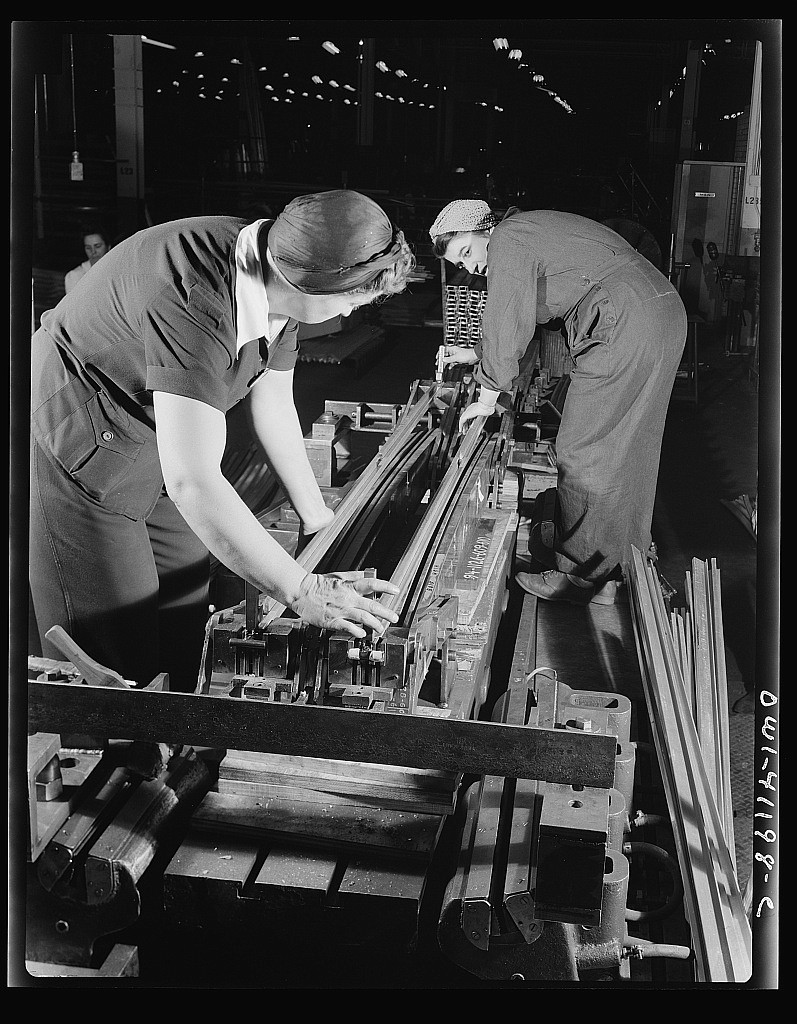 Boeing aircraft plant, Seattle, Washington. Production of B-17 (Flying Fortress) bombing planes. Two women working on a machine. Taken December 1942.