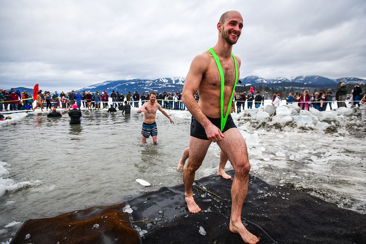 Participants step out of Whitefish Lake during the Penguin Plunge on Saturday, Feb. 4. Organized by the Law Enforcement Torch Run, as part of the Whitefish Winter Carnival, the event raised over $75,000 for Special Olympics Montana. (Casey Kreider/Daily Inter Lake)