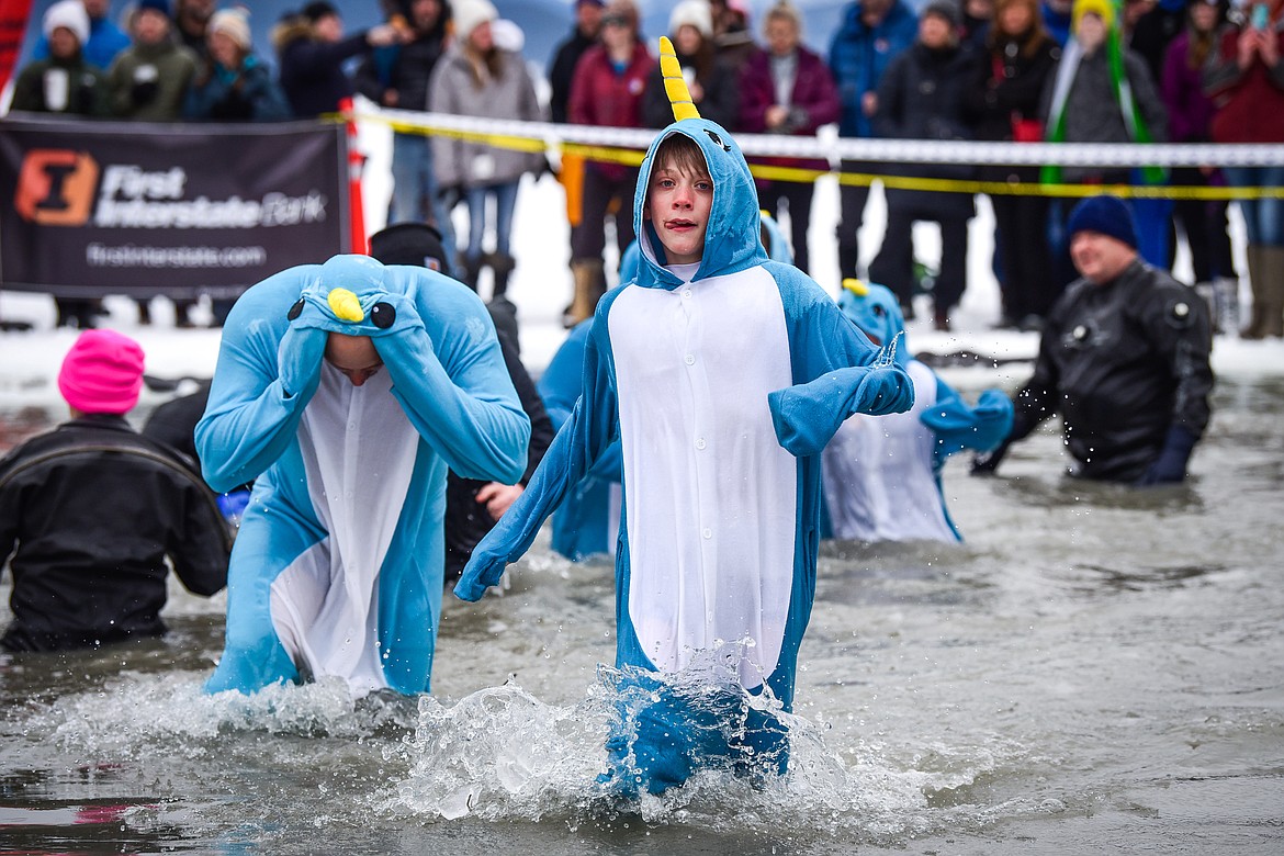 Participants step out of Whitefish Lake during the Penguin Plunge on Saturday, Feb. 4. Organized by the Law Enforcement Torch Run, as part of the Whitefish Winter Carnival, the event raised over $75,000 for Special Olympics Montana. (Casey Kreider/Daily Inter Lake)