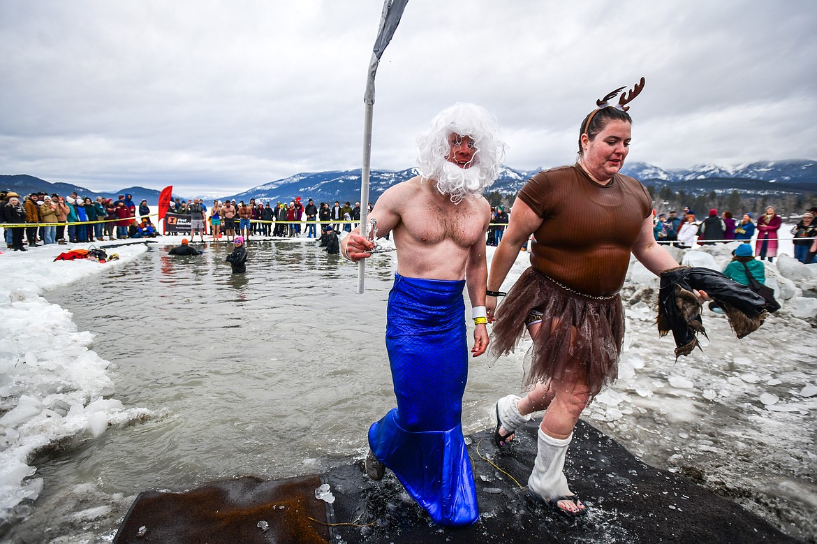 Participants step out of Whitefish Lake during the Penguin Plunge on Saturday, Feb. 4. Organized by the Law Enforcement Torch Run, as part of the Whitefish Winter Carnival, the event raised over $75,000 for Special Olympics Montana. (Casey Kreider/Daily Inter Lake)