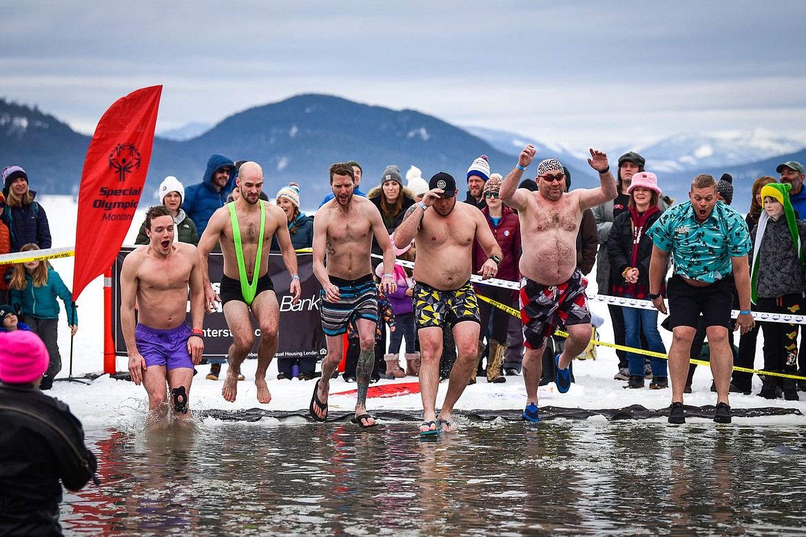 Participants leap into Whitefish Lake during the Penguin Plunge on Saturday, Feb. 4. Organized by the Law Enforcement Torch Run, as part of the Whitefish Winter Carnival, the event raised over $75,000 for Special Olympics Montana. (Casey Kreider/Daily Inter Lake)