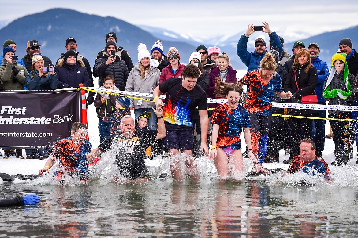 Whitefish Winter Carnival royalty leap into Whitefish Lake during the Penguin Plunge on Saturday, Feb. 4. Organized by the Law Enforcement Torch Run, as part of the Whitefish Winter Carnival, the event raised over $75,000 for Special Olympics Montana. (Casey Kreider/Daily Inter Lake)
