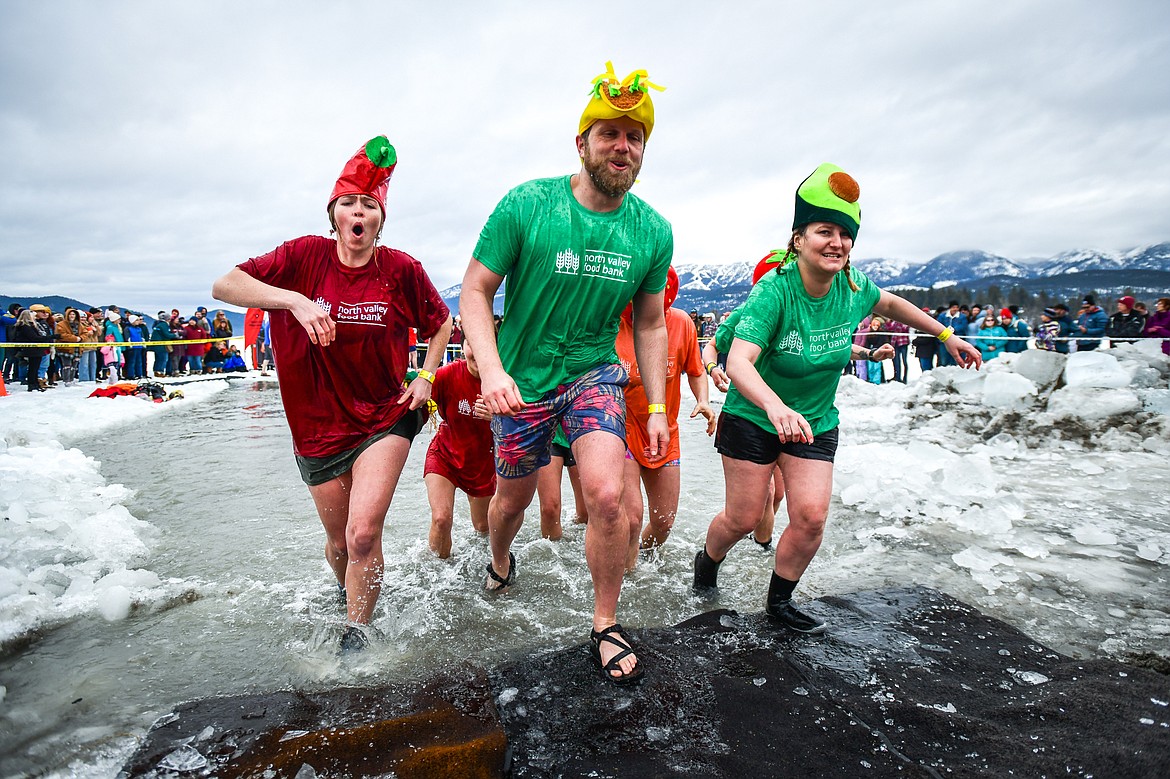 Participants from North Valley Food Bank step out of Whitefish Lake during the Penguin Plunge on Saturday, Feb. 4. Organized by the Law Enforcement Torch Run, as part of the Whitefish Winter Carnival, the event raised over $75,000 for Special Olympics Montana. (Casey Kreider/Daily Inter Lake)