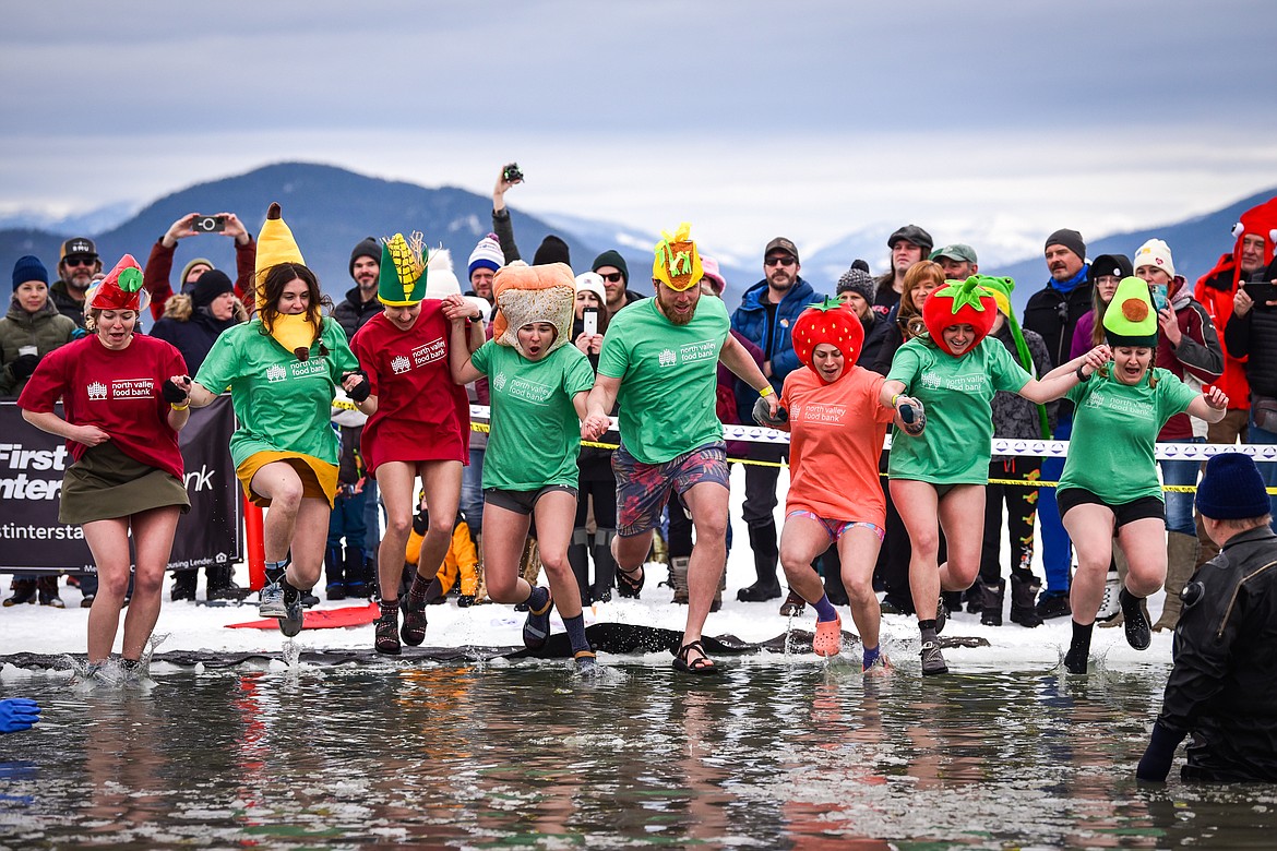 Participants from North Valley Food Bank leap into Whitefish Lake during the Penguin Plunge on Saturday, Feb. 4. Organized by the Law Enforcement Torch Run, as part of the Whitefish Winter Carnival, the event raised over $75,000 for Special Olympics Montana. (Casey Kreider/Daily Inter Lake)