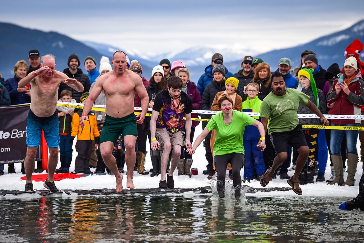 Participants leap into Whitefish Lake during the Penguin Plunge on Saturday, Feb. 4. Organized by the Law Enforcement Torch Run, as part of the Whitefish Winter Carnival, the event raised over $75,000 for Special Olympics Montana. (Casey Kreider/Daily Inter Lake)