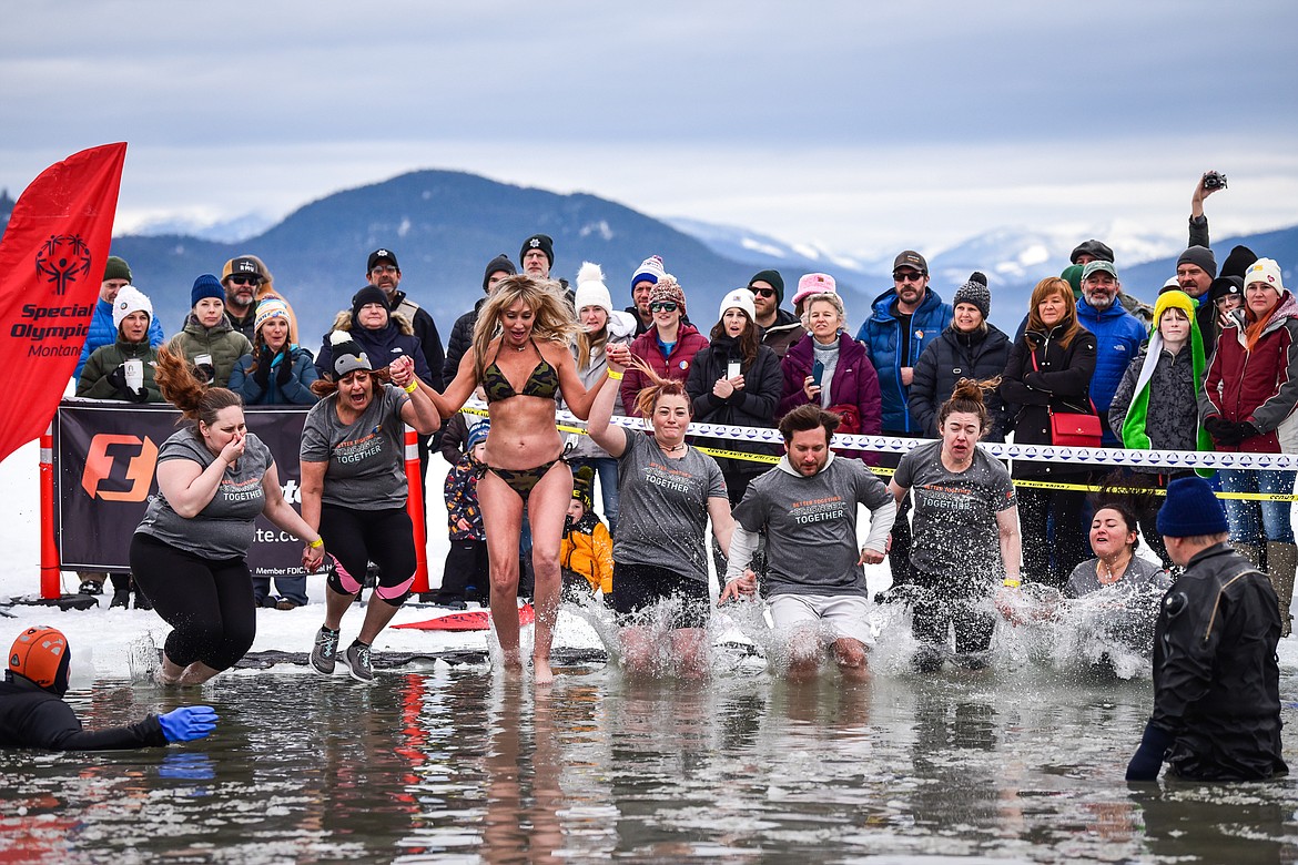 Participants leap into Whitefish Lake during the Penguin Plunge on Saturday, Feb. 4. Organized by the Law Enforcement Torch Run, as part of the Whitefish Winter Carnival, the event raised over $75,000 for Special Olympics Montana. (Casey Kreider/Daily Inter Lake)