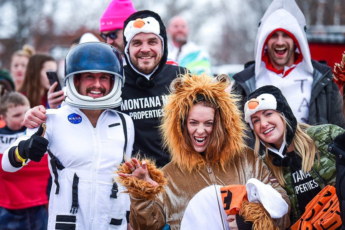 Participants in costumes wait in line to leap into Whitefish Lake during the Penguin Plunge on Saturday, Feb. 4. Organized by the Law Enforcement Torch Run, as part of the Whitefish Winter Carnival, the event raised over $75,000 for Special Olympics Montana. (Casey Kreider/Daily Inter Lake)