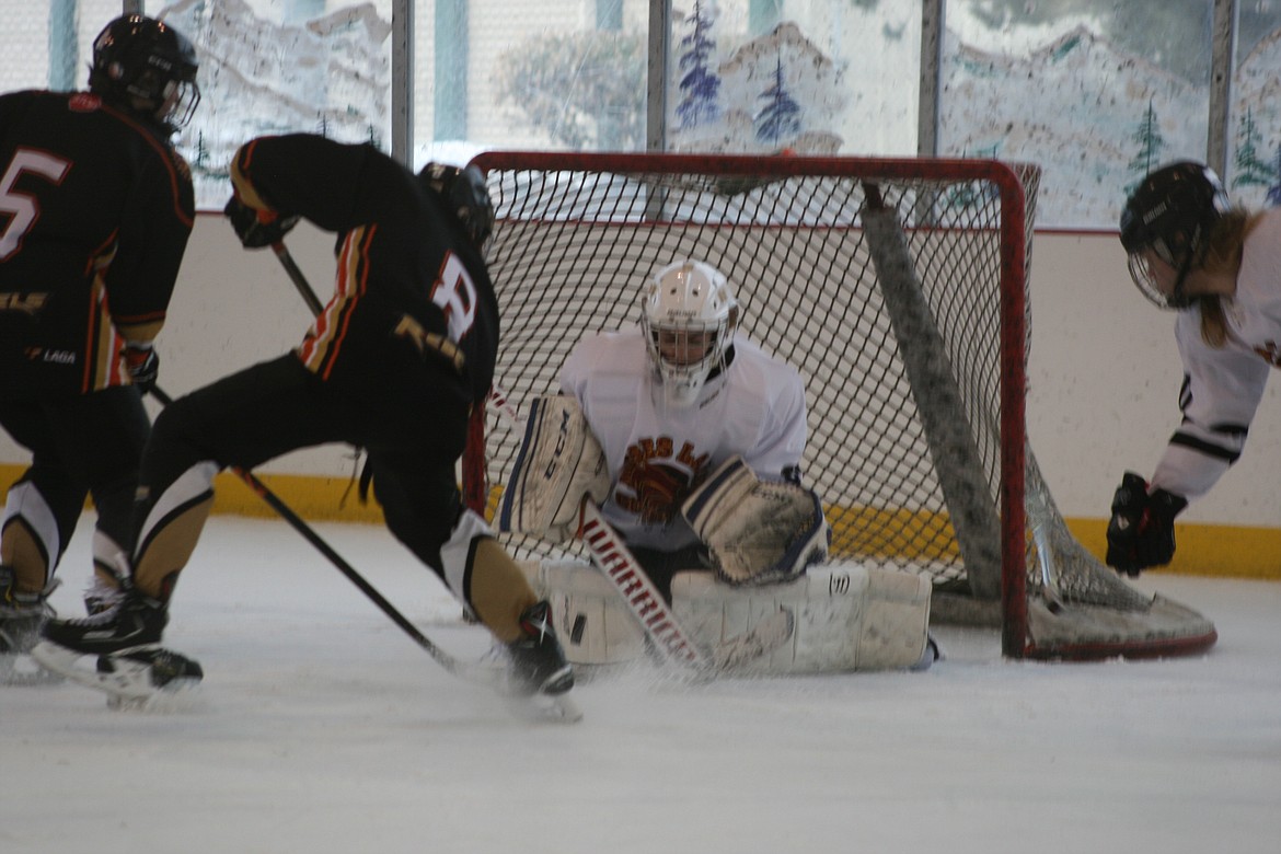 Moses Lake Coyotes goalie Wyatt Horst defends the net against a Castlegar shot during the Moses Lake Winter Classic 18U hockey tournament Saturday morning. The teams tied 2-2. The tournament concluded Sunday; results will be available in the Tuesday edition of the Columbia Basin Herald.