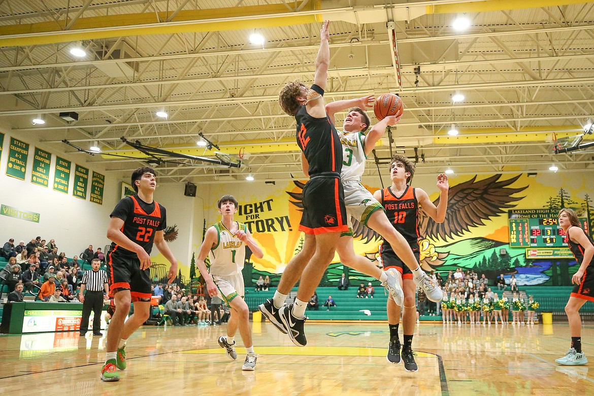 JASON DUCHOW PHOTOGRAPHY
Scotty Hocking of Lakeland goes up for a shot as Cooper Craig (12) of Post Falls defends on Saturday night in Rathdrum.