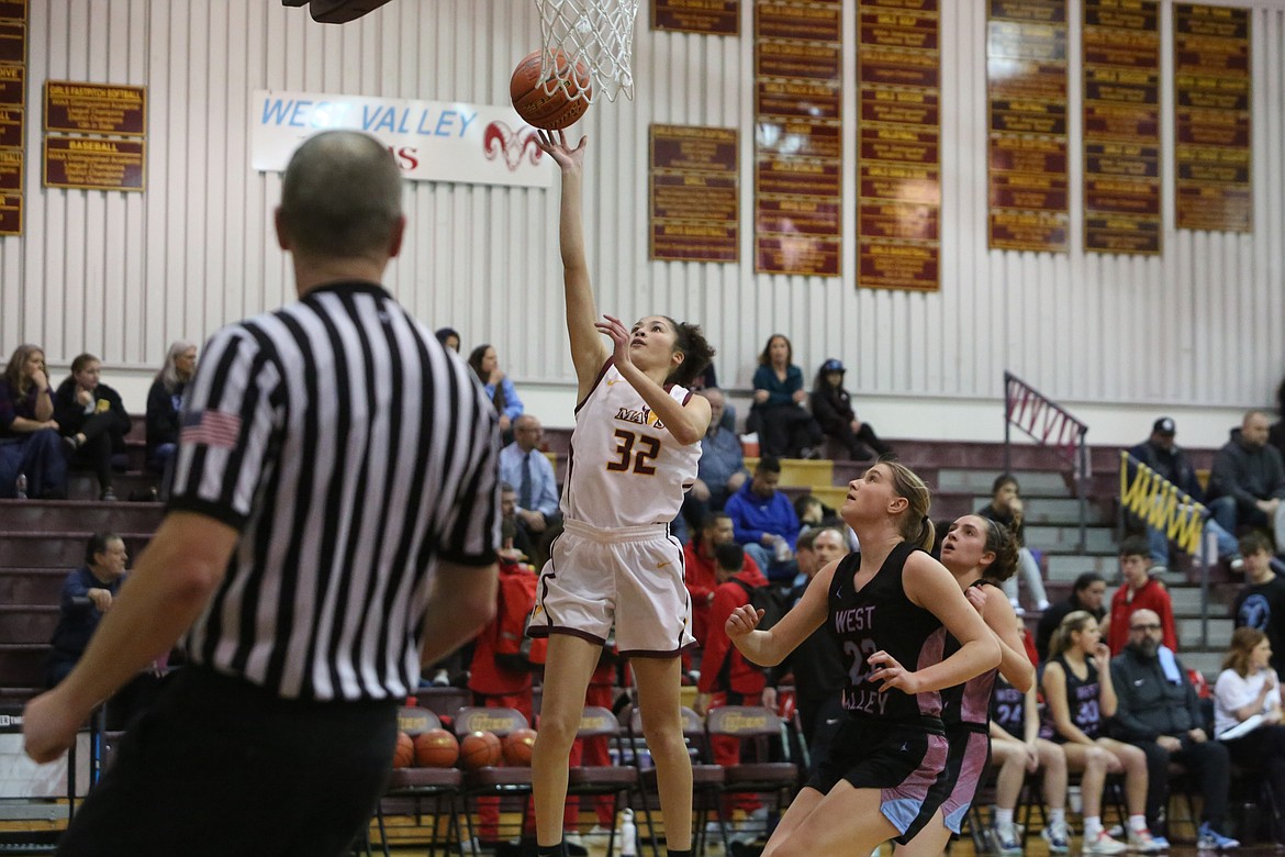 Moses Lake sophomore Madison Bond (32) scores on a layup in transition.