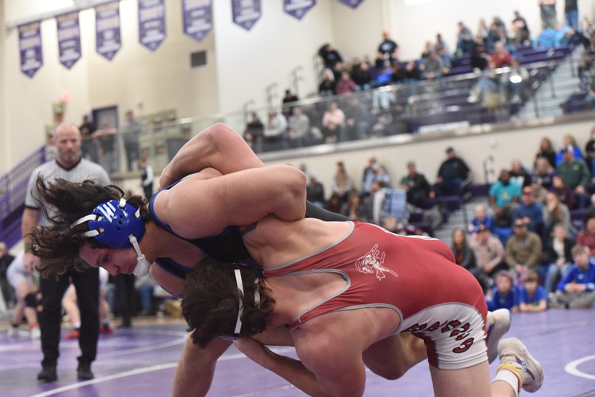 Libby's Jace DeShazer throws Hamilton's Derrick Saltman at the Western Class A tournament in Polson. (Scott Shindledecker/The Western News)