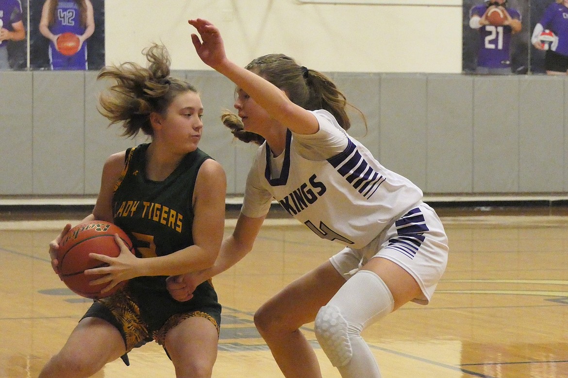 St. Regis guard Shylah Dalka is guarded by Charlo's Sheadon Kain during their game Saturday night in Charlo, won by the Lady Vikings, 45-43. (Chuck Bandel, Valley Press)