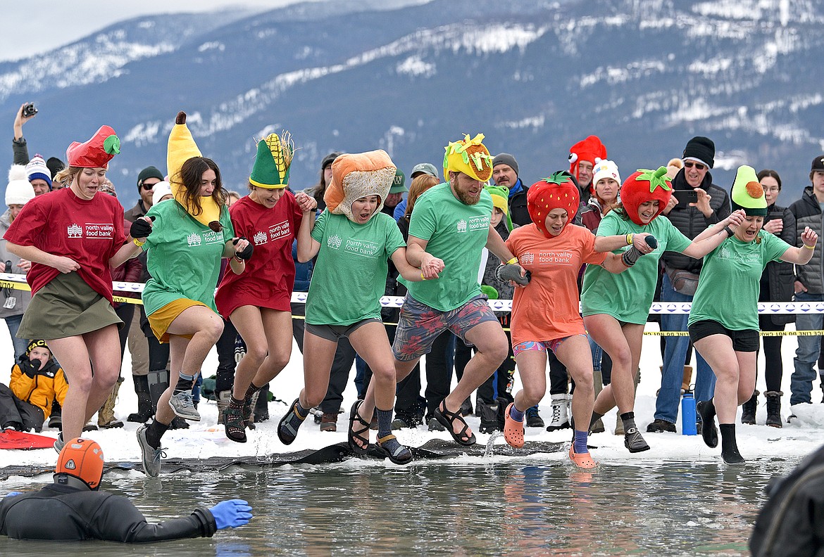 The crew from the North Valley Food Bank dressed as various foods jumps into the icy cold water at the Penguin Plunge on Saturday at City Beach. (Whitney England/Whitefish Pilot)