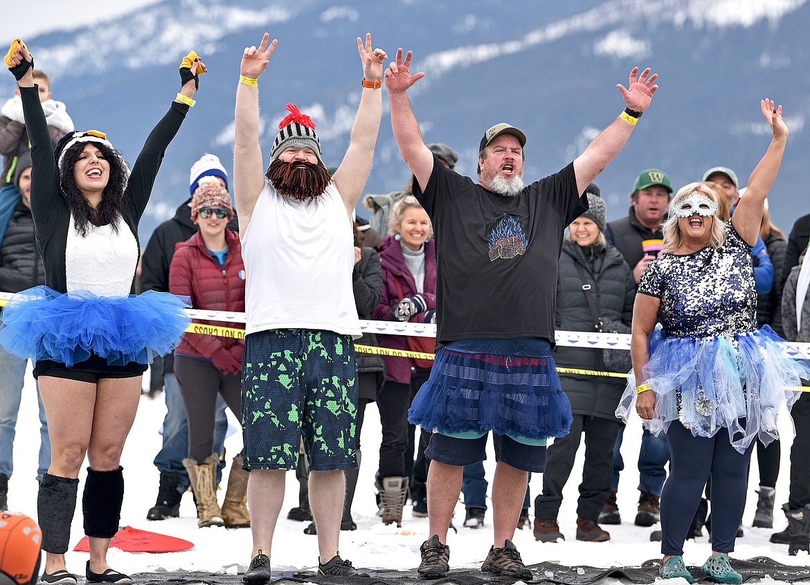 A group dressed in costumes from the Whitefish Credit Union readies to jump into the icy cold water at the Penguin Plunge on Saturday at City Beach. (Whitney England/Whitefish Pilot)