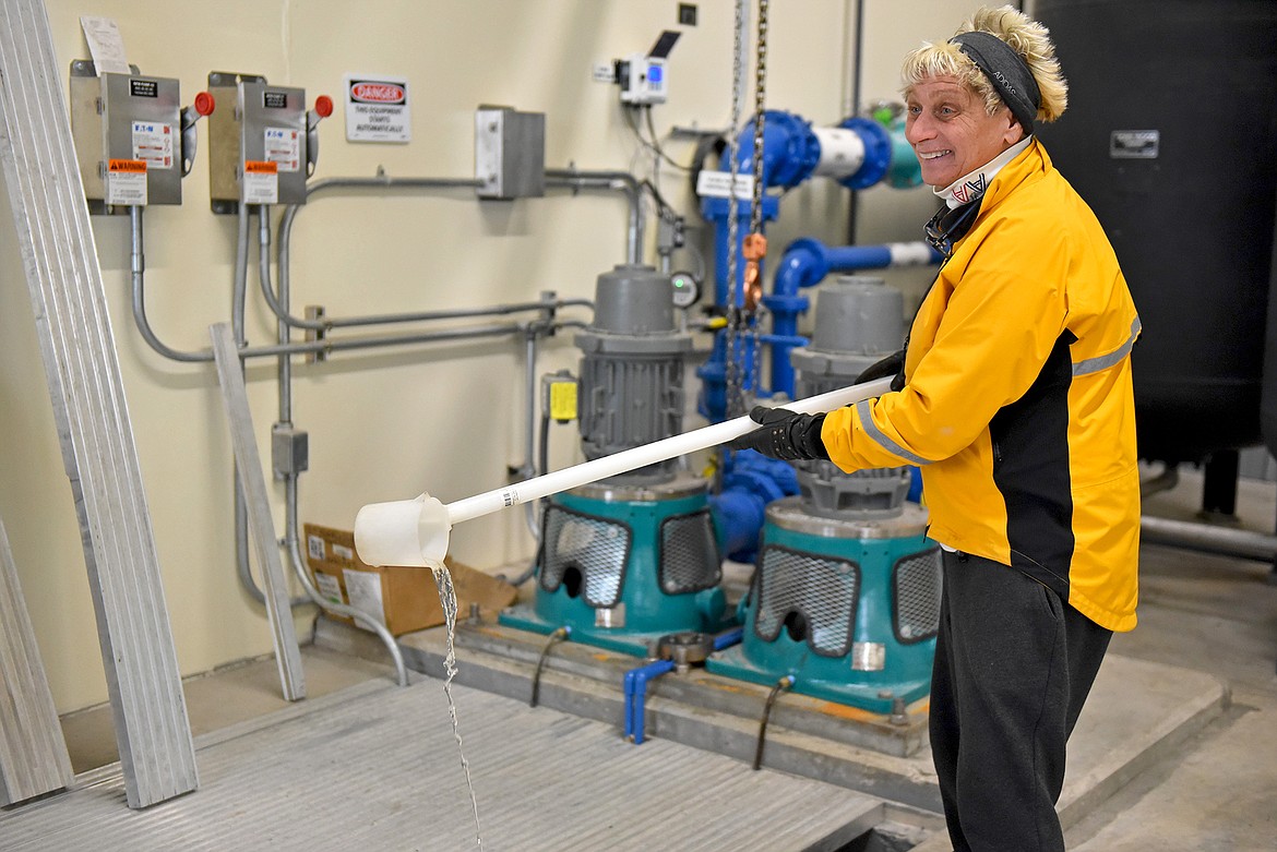 Chomas shows a sample of the clean, completely treated water that is on its way to the Whitefish River. (Julie Engler/Whitefish Pilot)