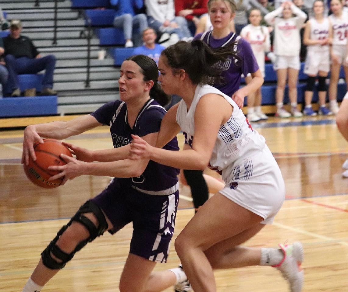 Superior's Akasha Azure (white jersey) goes for a steal from Charlo's Hayleigh Smith during the Lady Bobcats narrow win over the Lady Vikings Saturday night in Superior.  (photo by Kami Milender)