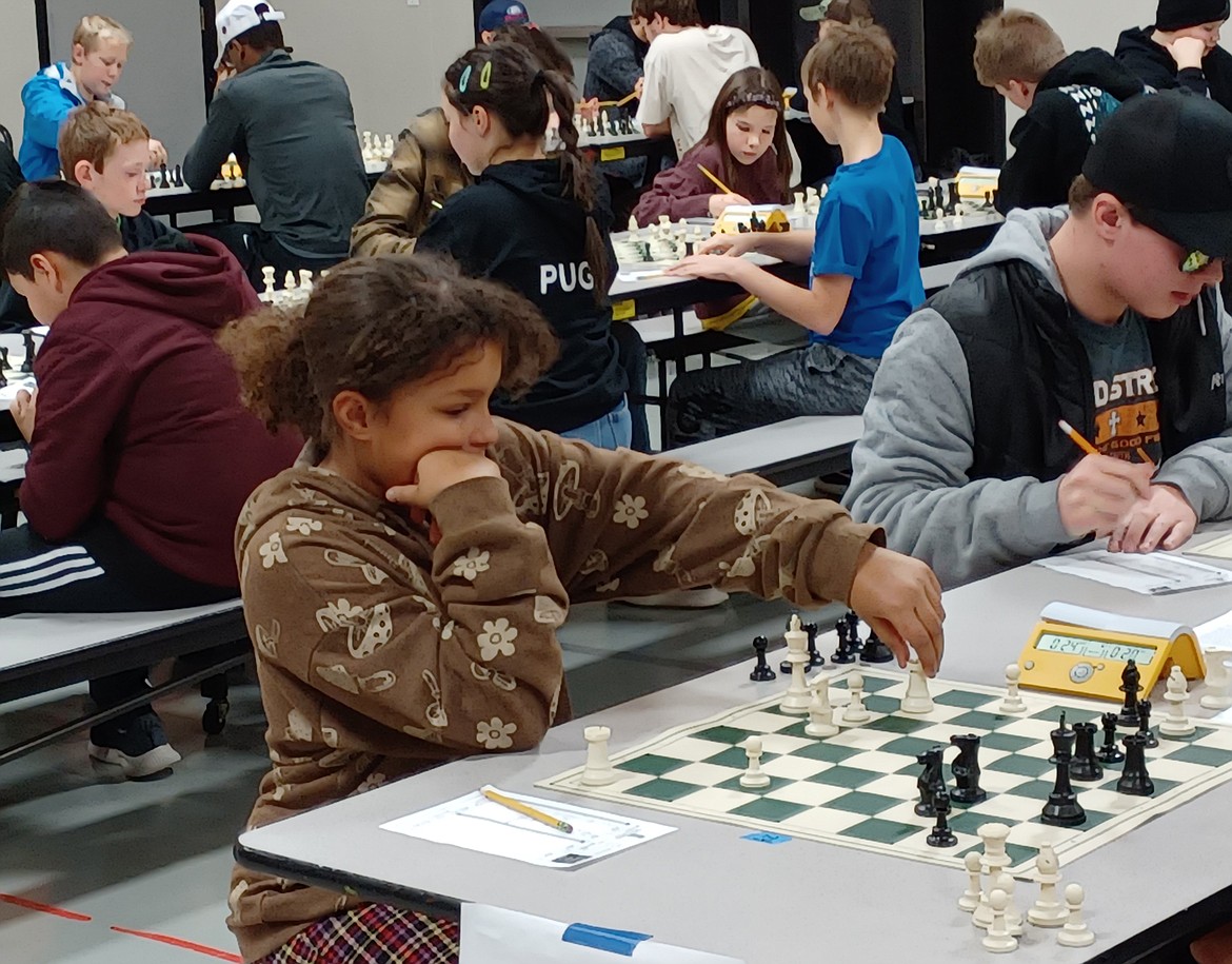 Liliana Henning, 10, ponders her move in the first round of the Waypoint Foundation Scholastic Chess Tournament Saturday. She just learned the game about a month ago, her mother said.