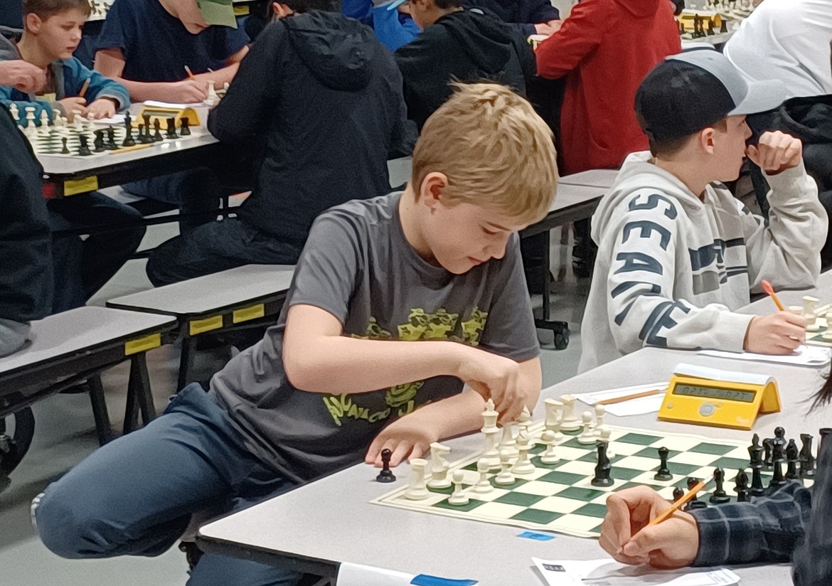 Nine-year-old Kenny Colver of Ephrata is a little fidgety in his seat but makes his move with confidence at the  Waypoint Foundation Scholastic Chess Tournament Saturday.