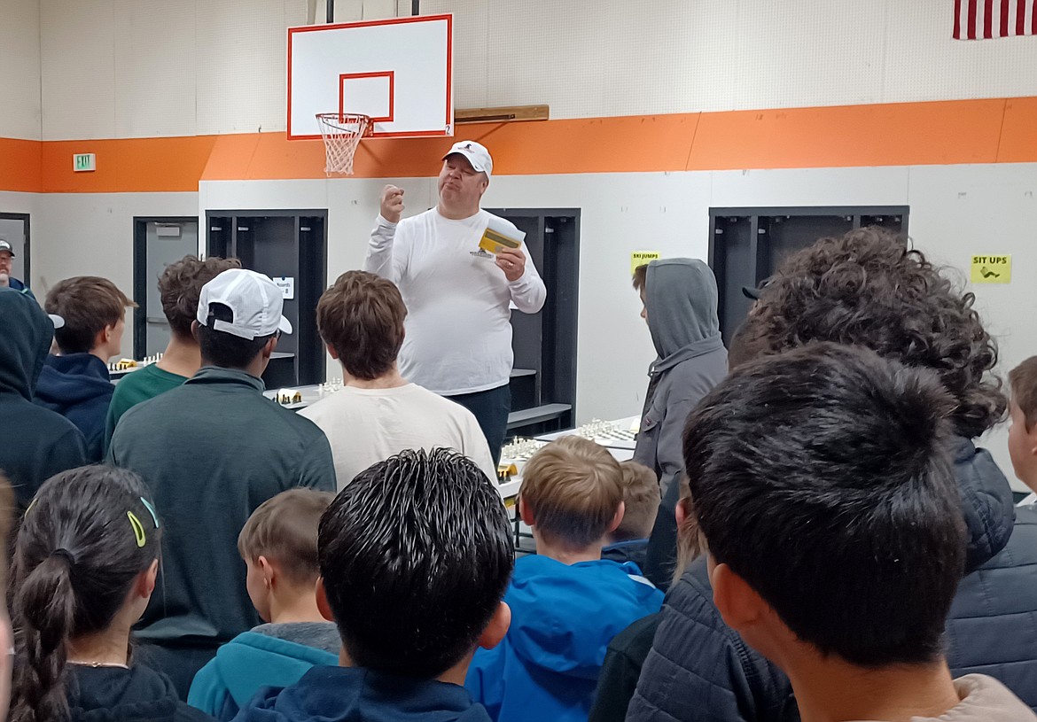 Roger Pugh, co-sponsor with his brother Troy Pugh of the  Waypoint Foundation Scholastic Chess Tournament, explains the procedure to the kids about to face off Saturday.