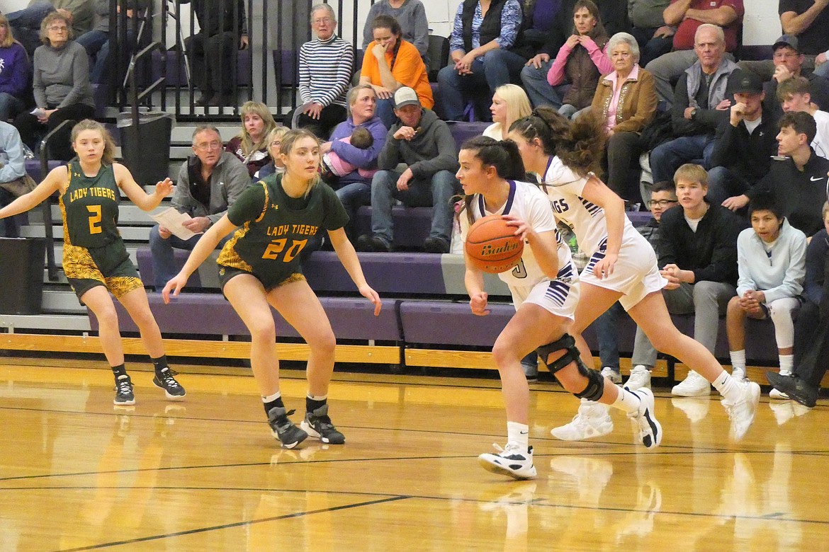 Charlo's Hayleigh Smith dribbles toward the basket, guarded by St. Regis forward Bailey Hutchinson during their game Friday in Charlo, won by the Lady Vikings on a last second shot. (Chuck Bandel/VP-MI)